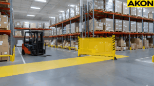 Industrial retractable barrier guiding forklift traffic through a shared warehouse aisle