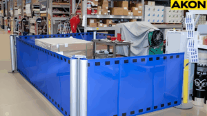 Industrial retractable barriers isolating a temporary staging area inside a warehouse aisle