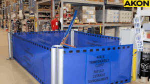Portable retractable barriers system creating a temporary closed aisle in a warehouse