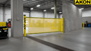 Warehouse aisle secured with a retractable barrier fence to manage a spill zones