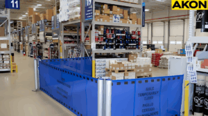 Warehouse inspection and QA hold zone enclosed with retractable barrier system in retail distribution centers