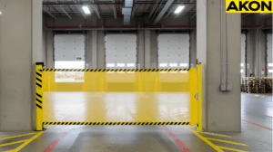 Yellow retractable safety barrier blocking an open warehouse dock door during inactive loadings